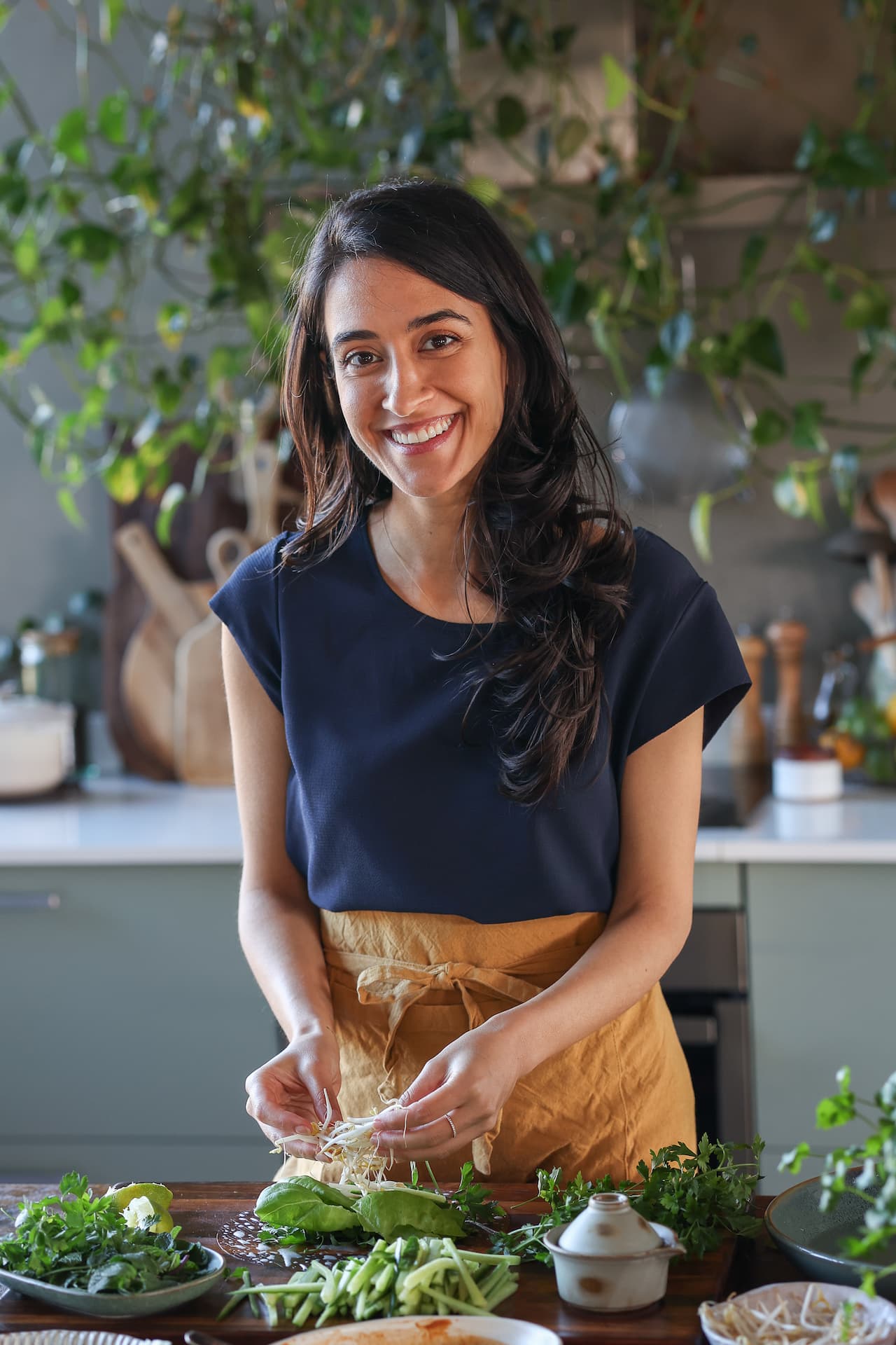 Sadia Badiei making fresh plant-based rolls in the Pick Up Limes kitchen